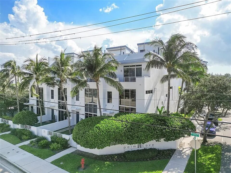 Aerial view of Palm Cove Lofts and its palm-lined entrance sign at A1A and NE 15th Street